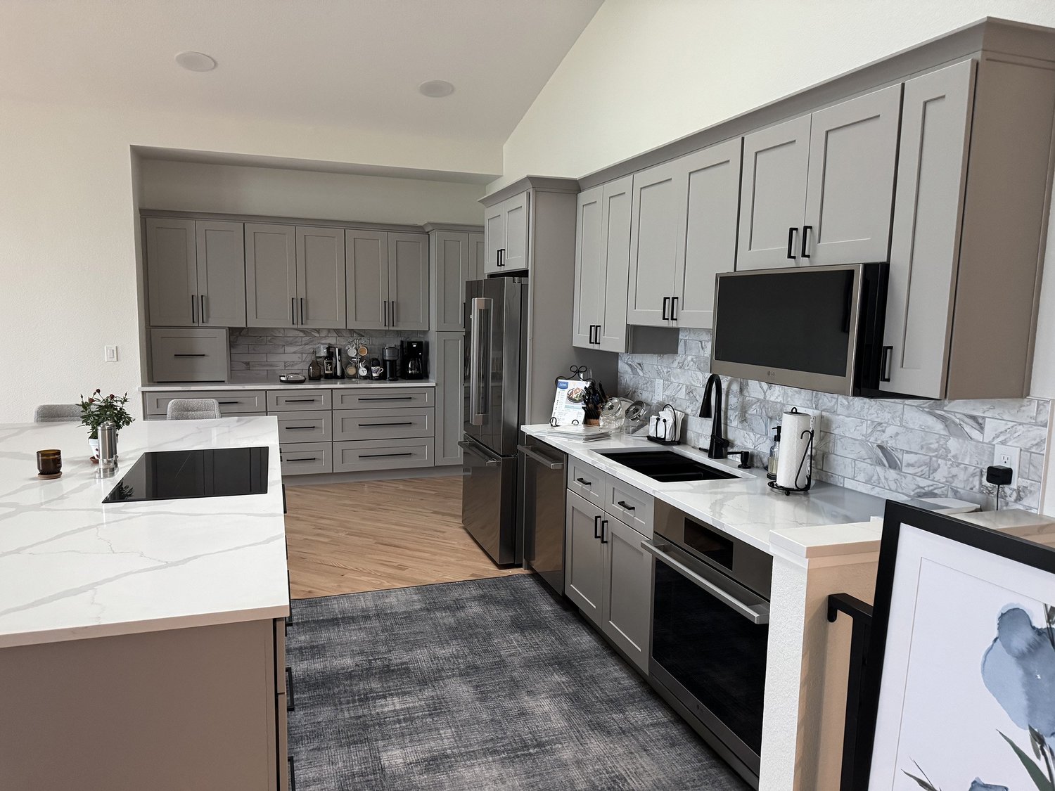 Remodeled kitchen with a marble island and custom cabinetry