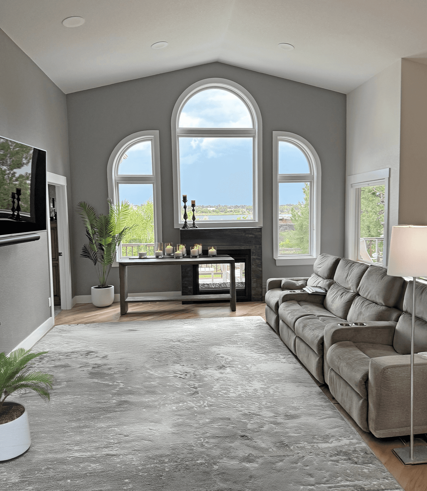 Bright renovated living room with tall arched windows